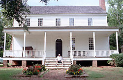 Walt Krus takes a break at the House in the Horseshoe State Historic Site. The house was the site of a Revolutionary War skirmish, and bullet holes remain in the exterior of the home.