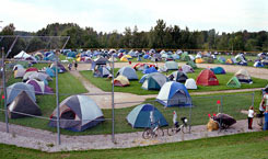 Tents of 2001 DALMAC riders take over the baseball diamond at McBain High School.