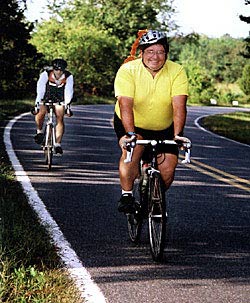 Roger Kramer, donning an orange ponytail, and Doug Kaufman make their way along the "moderate rolling hills" between Statesville and the first rest stop. (Photograph by Jim Harris)