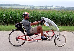 A man riding a
            recumbent bicycle passes farm fields near the Horicon
            National Wildlife Refuge.